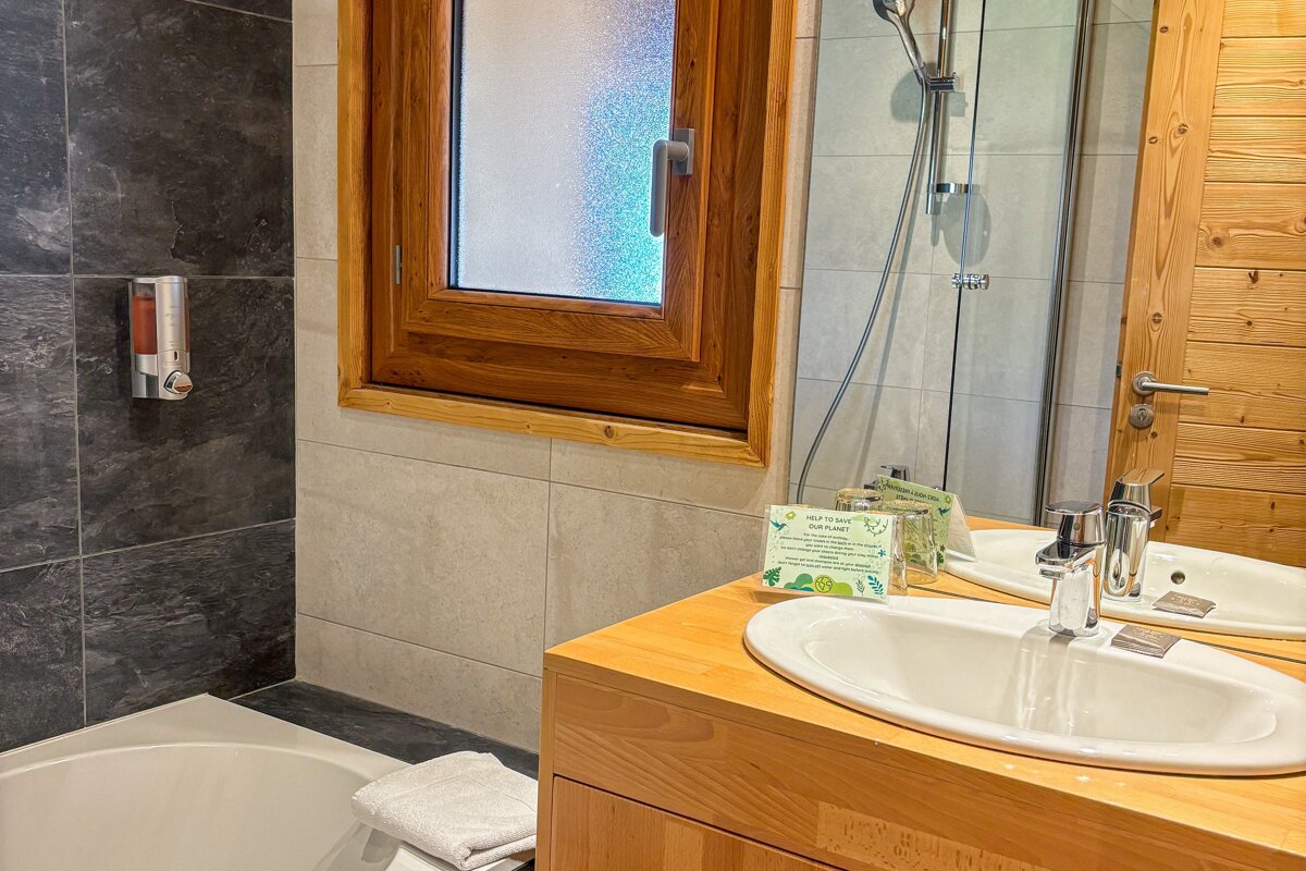 A bathroom with a sink a mirror and a window