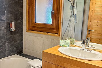 A bathroom with a sink a mirror and a window