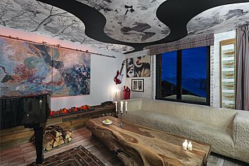 A living room with a piano and a couch