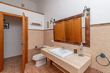 A bathroom with a toilet a sink and a mirror