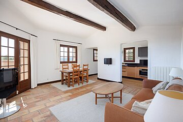A living room with a couch a table and chairs