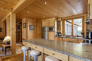 A kitchen with granite counter tops and wooden cabinets