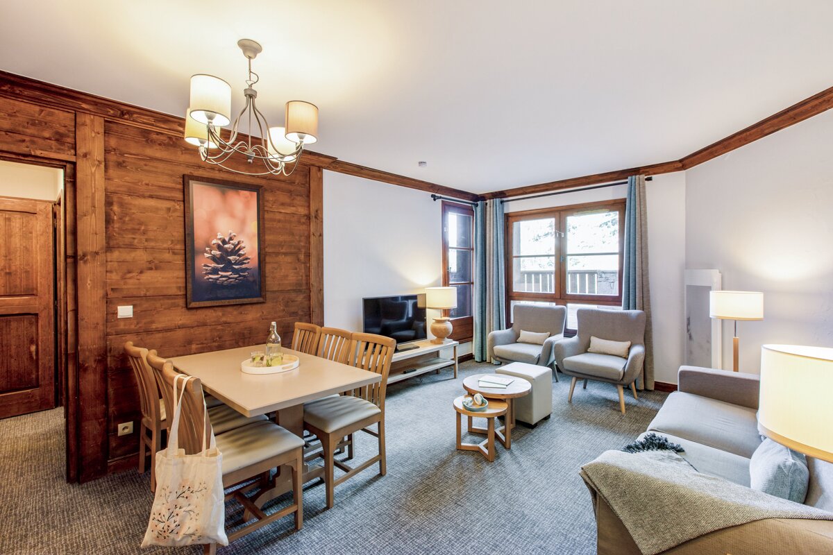 A living room with a dining table and chairs