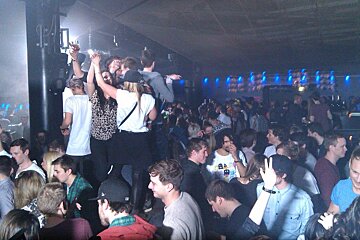 a crowd partying in a nightclub
