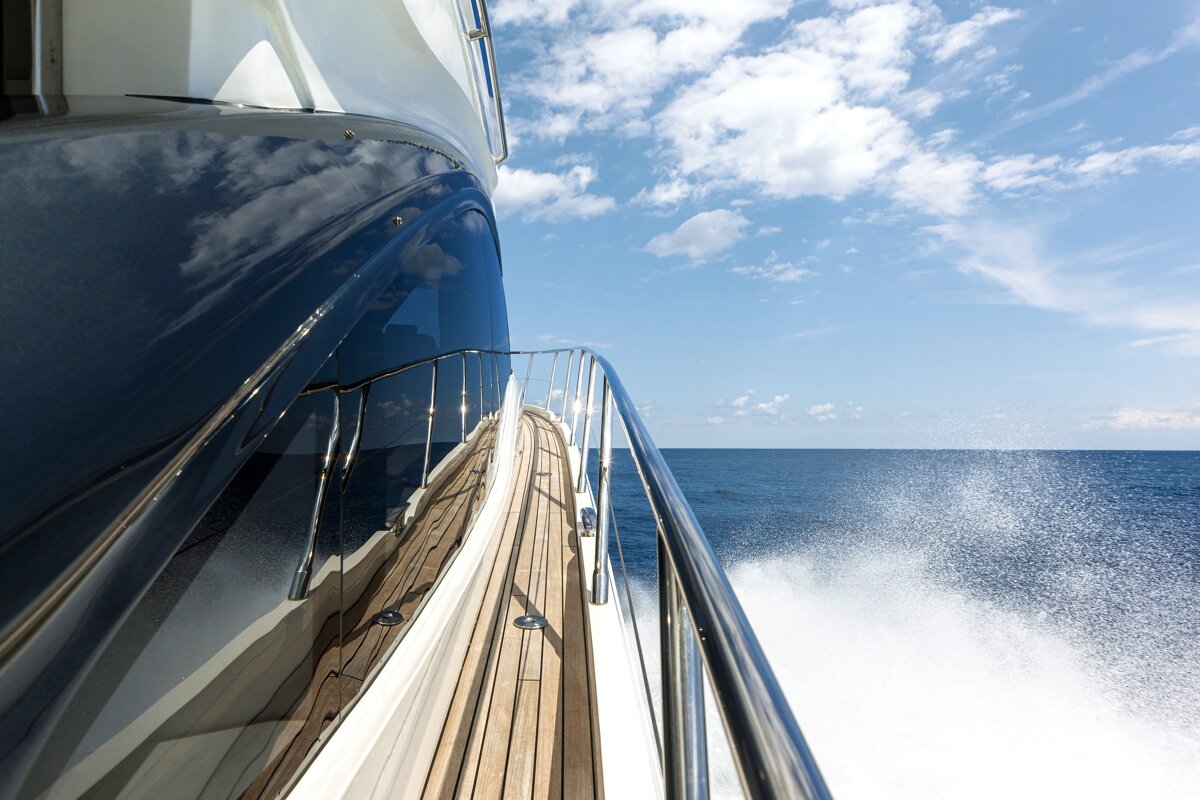 A boat with a wooden deck is floating in the ocean