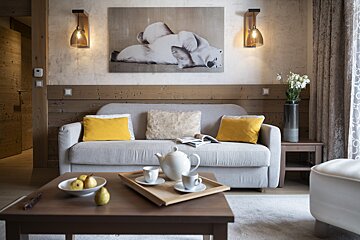A living room with a couch and a picture of a polar bear on the wall