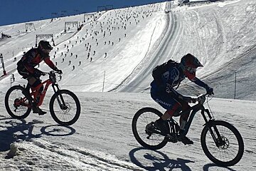 mountain bikers on snow