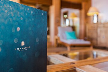 A blue book titled deep nature spa & wellness