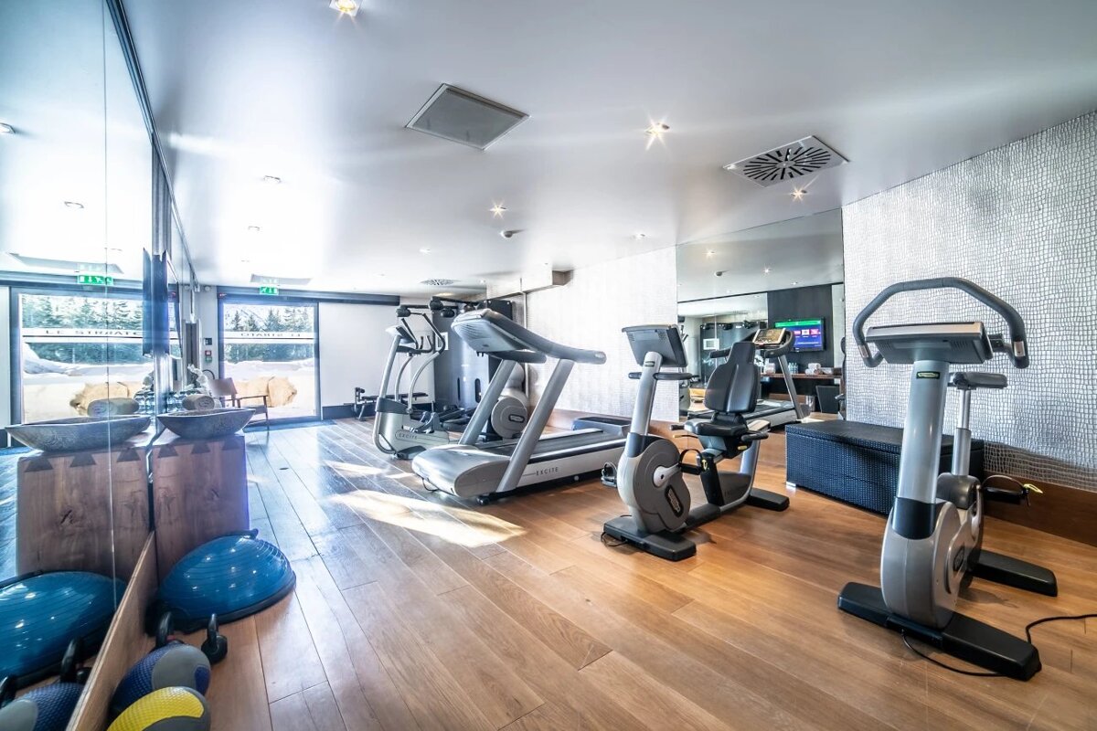 A gym with treadmills and exercise bikes and a sign that says exit