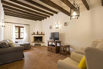 A living room with a fireplace and a flat screen tv