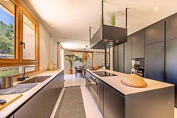 A kitchen with black cabinets and white counter tops