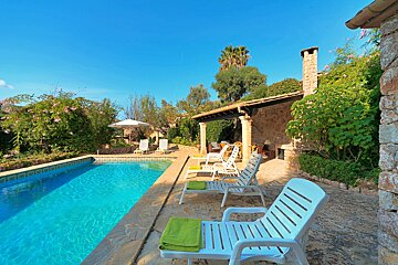 A swimming pool with chairs and umbrellas around it