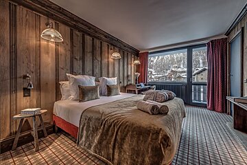 A hotel room with a large bed and a balcony