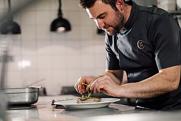 A chef wearing a shirt with the number 17 on it