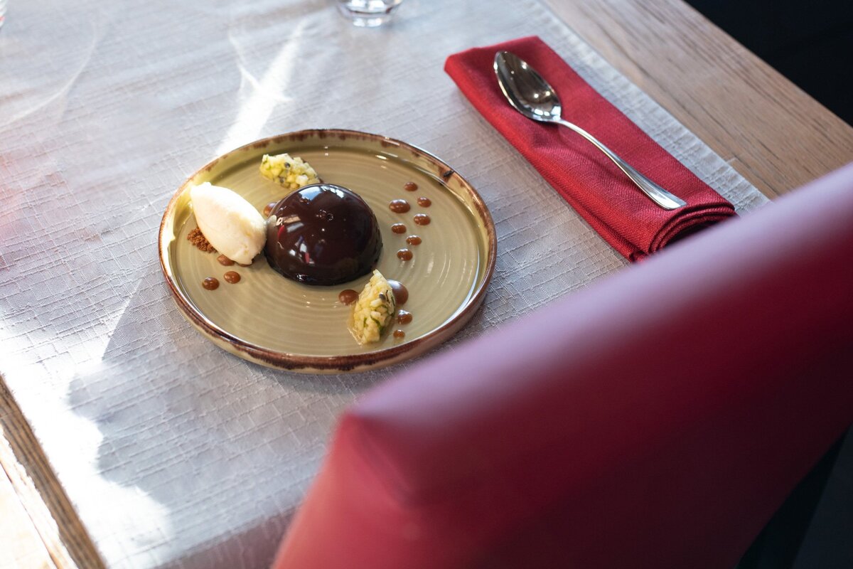 A plate of food with a spoon and napkin on a table
