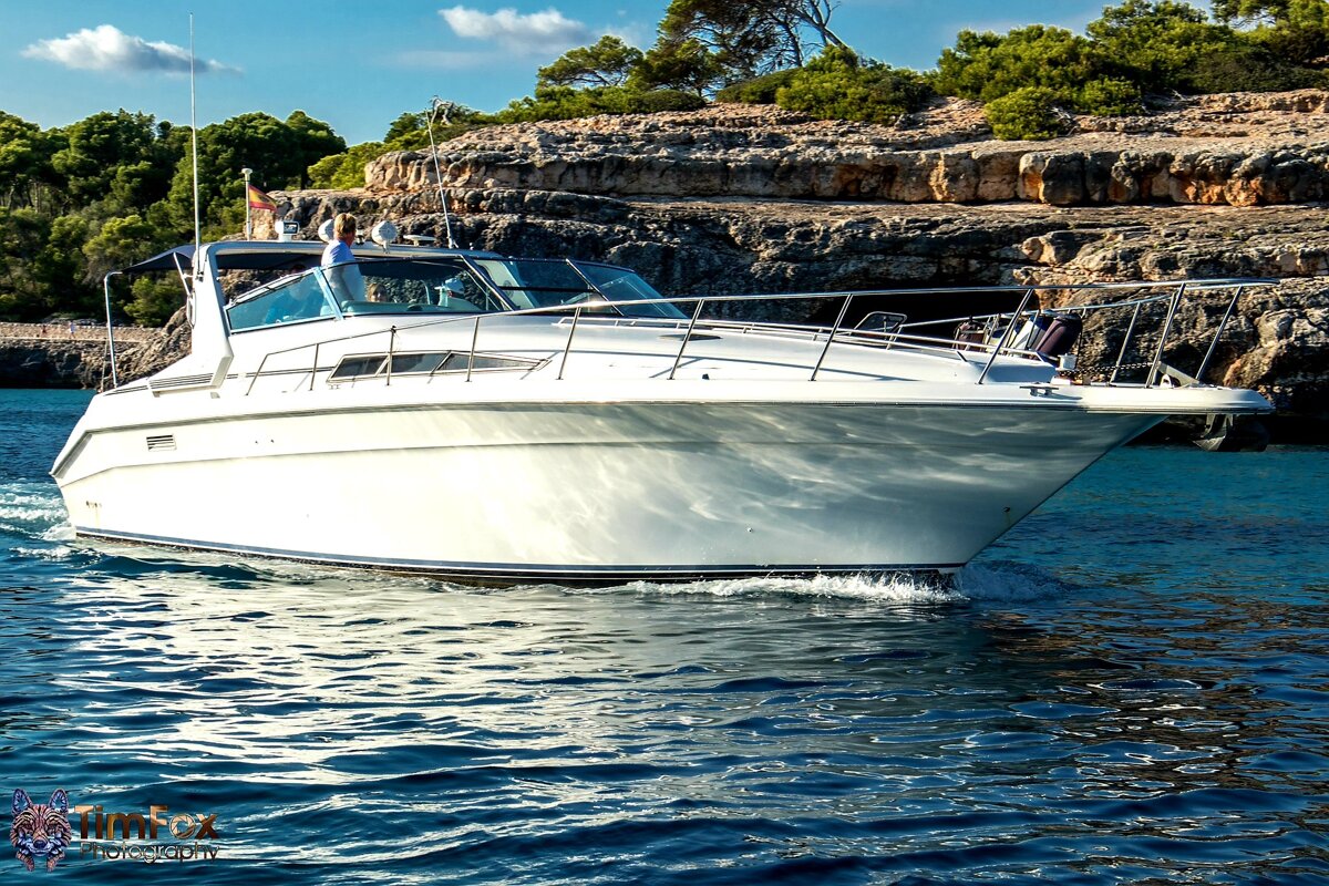 A white boat is floating in the water with the word firefox on the bottom