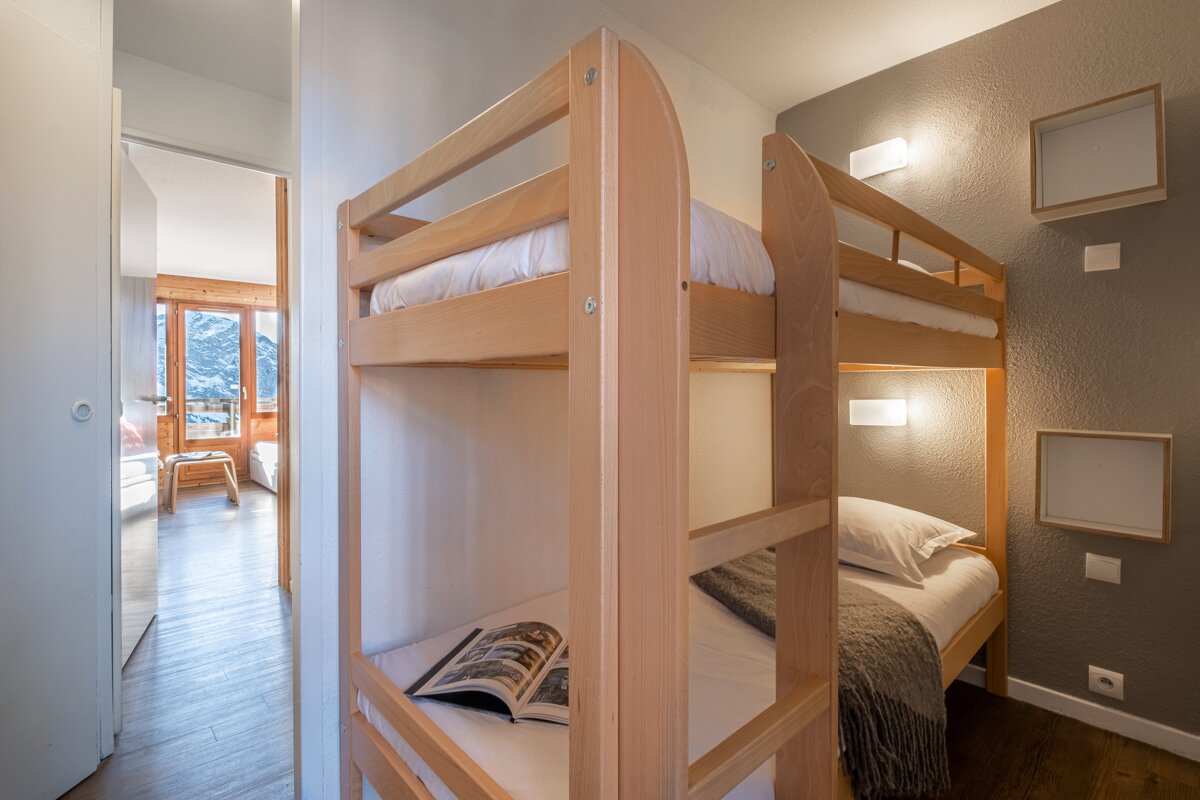 A bunk bed with a magazine on top of it