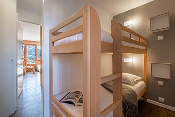 A bunk bed with a magazine on top of it