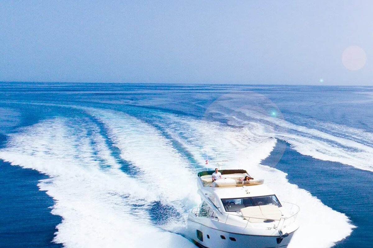 A white yacht is going through the ocean