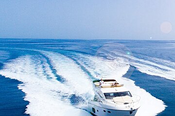 A white yacht is going through the ocean