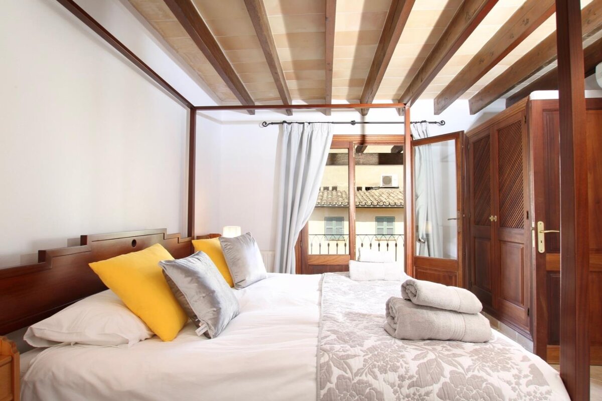 A bedroom with a canopy bed and a window