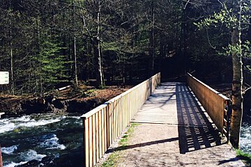 a bridge crossing the river in morzine