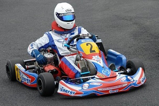A person is riding a go kart with the number 2 on it