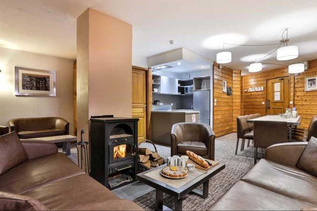 A living room with a fireplace and a table with a sign that says ' caban ' on it