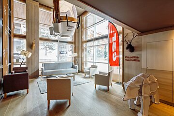 A living room with a couch and chairs and a sign that says les petites marmottes