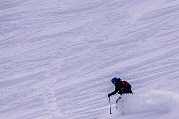 a skier turning in deep snow