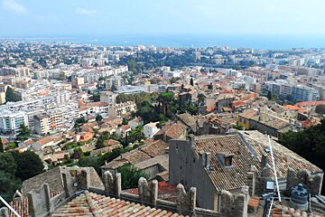 An aerial view of a city with the ocean in the background