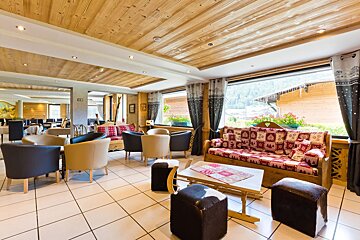 A living room with a couch and chairs and a window