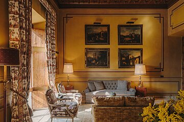 A living room with a couch and four paintings on the wall