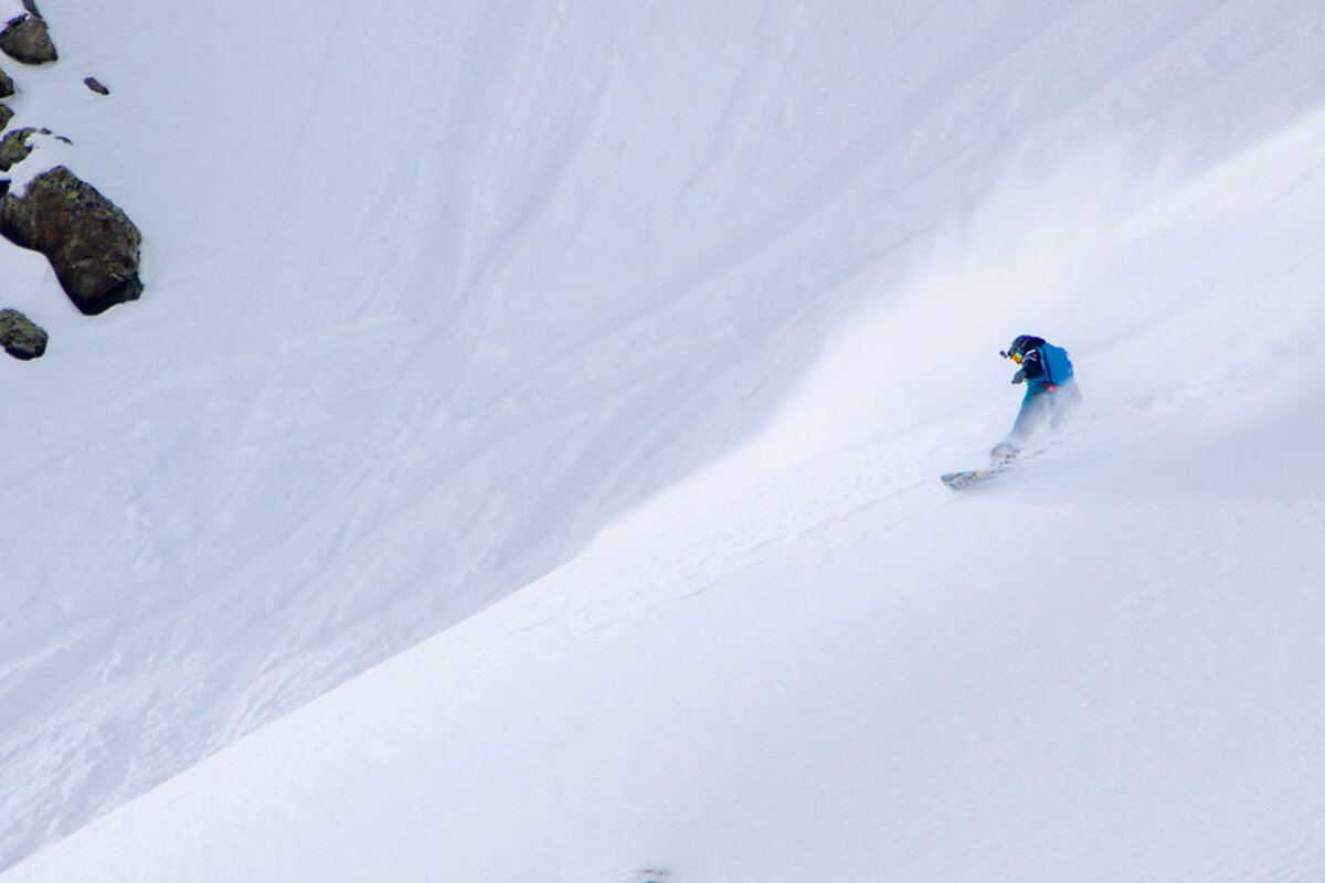 a female snowboarder in the powder