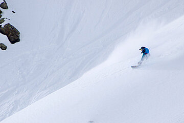 a female snowboarder in the powder
