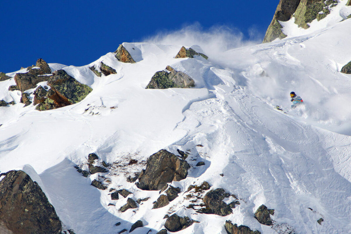 A person skiing down a snow covered mountain