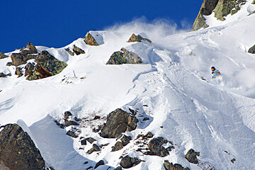 A person skiing down a snow covered mountain