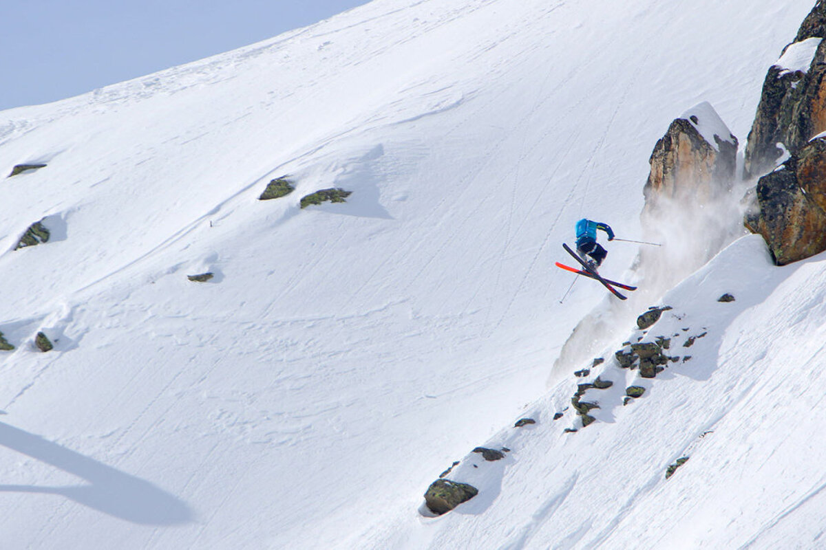 a skier spinning off a cliff