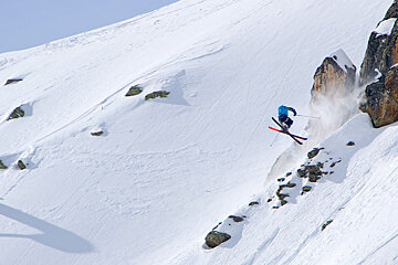 a skier spinning off a cliff
