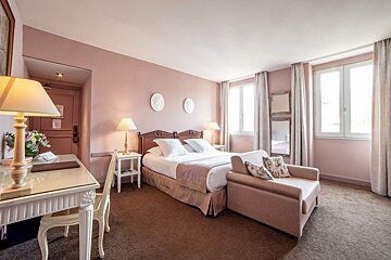 A hotel room with pink walls and a bed