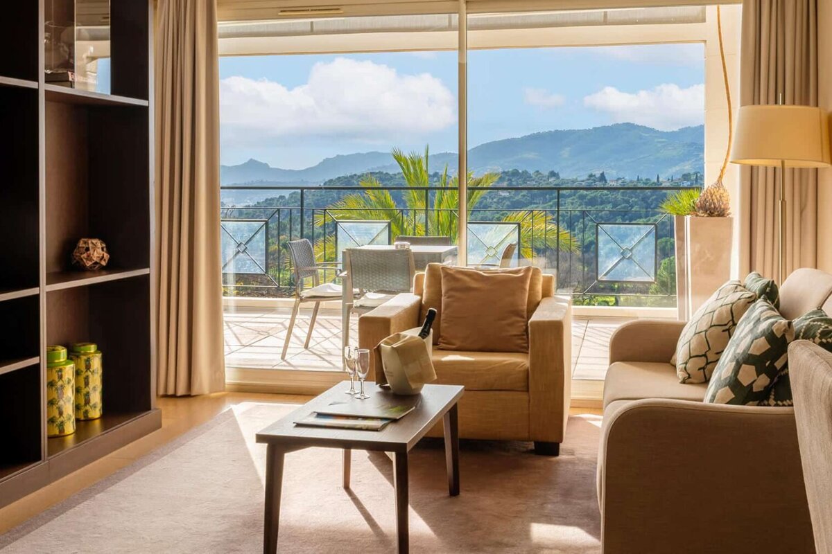 A living room with a view of mountains and trees