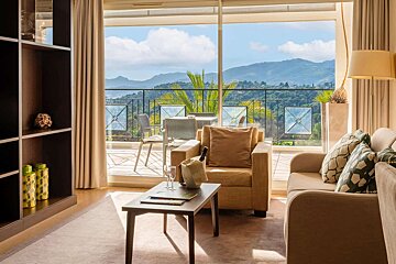 A living room with a view of mountains and trees