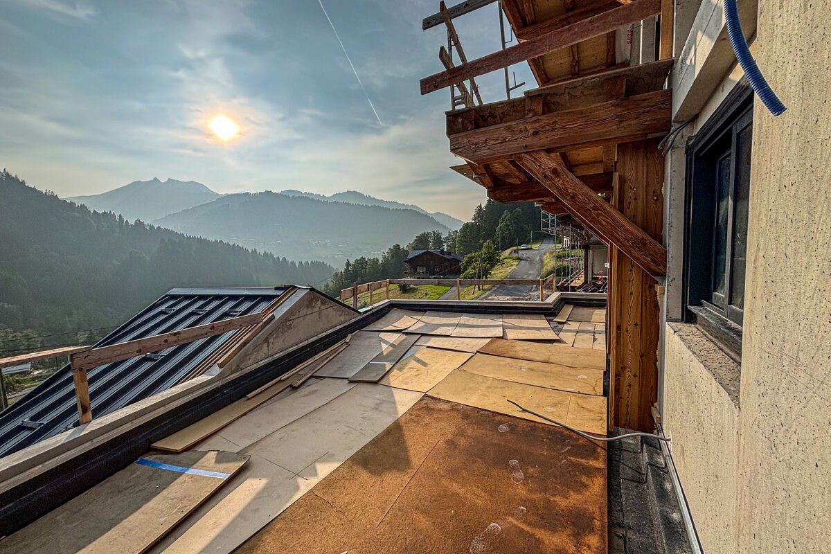 A building under construction with a view of mountains in the background