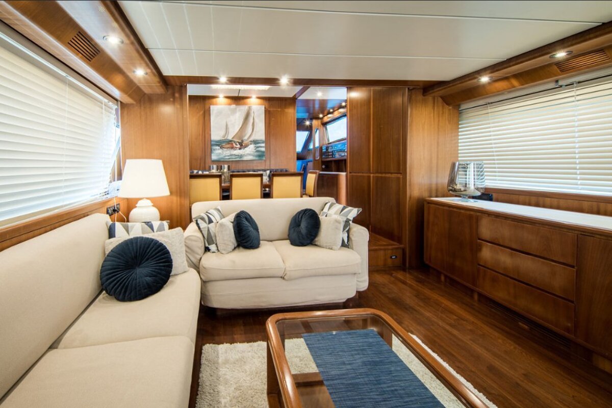 A living room with a white couch and blue pillows