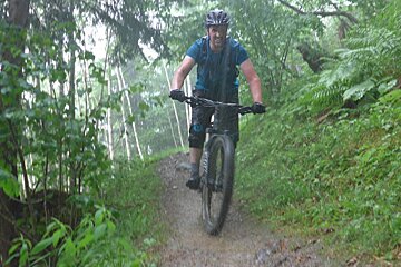 a mountain biker in the rain in chamonix