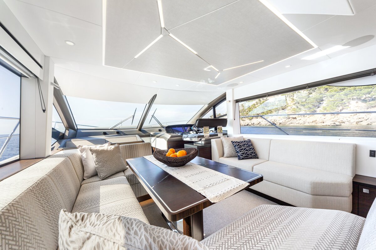 A living room on a boat with a table and a couch
