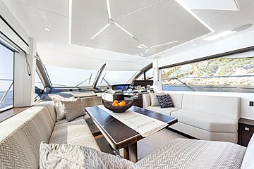 A living room on a boat with a table and a couch