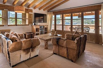 A living room with a couch and two chairs