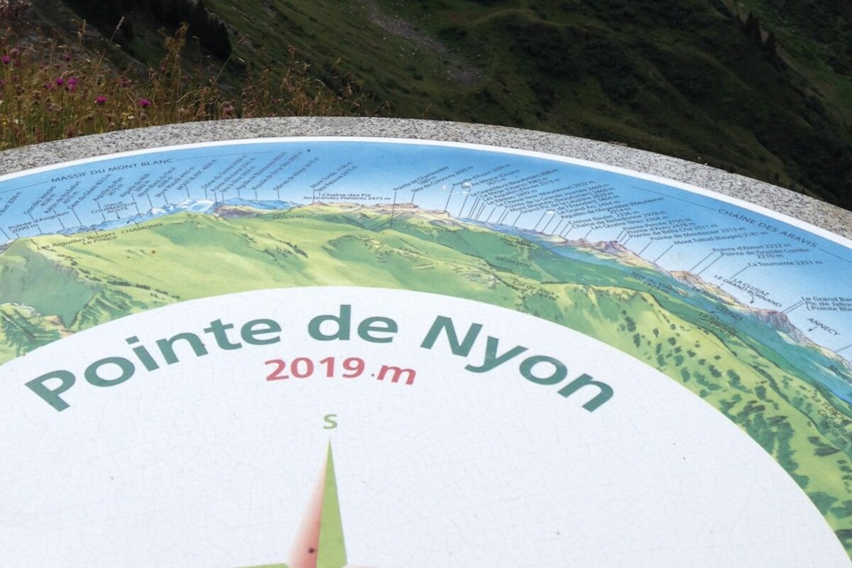 a trig point marking mountain views near morzine