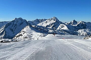 On the snowy groomed slopes in Les 2Alpes on a sunny day